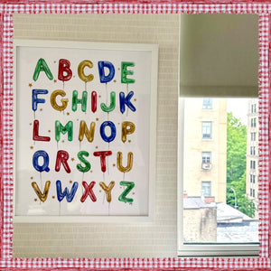 Balloon Alphabet in Multicolor in White Frame hanging in an NYC nursery 