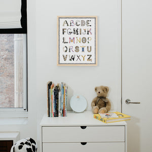 Chess Alphabet with Black Gingham Border and Natural Frame hanging in a nursery