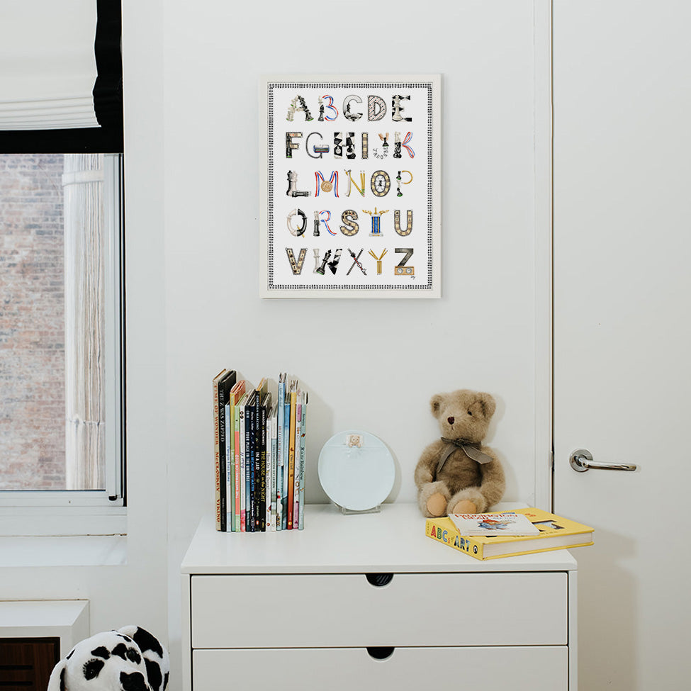 Chess Alphabet with Black Gingham Border and White Frame hanging in a nursery