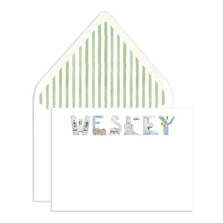 Card with 'WESLEY' spelled out using Washington, D.C. letters on a background of an envelope liner with green watercolor stripes