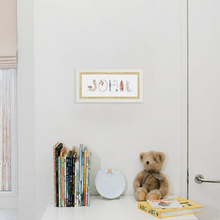 Nautical Custom Name Print by The Letter Nest in a white frame in name "John" with braided rope border, hung up in nursery