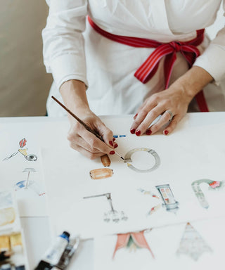photo of Sally McBride painting a Paris them letter "O" 