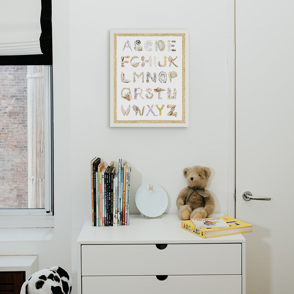 Shell Alphabet with Braided Rope border, shown in a White Frame installed in nursery