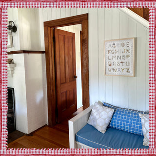 Shell Alphabet with Scallop Border in Natural Frame hanging in the foyer of a summer house 