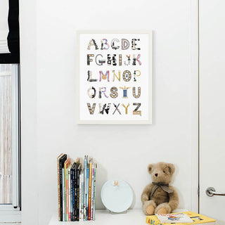 Chess Alphabet with white frame hanging in a nursery