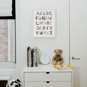 Chess Alphabet with white frame hanging in a nursery