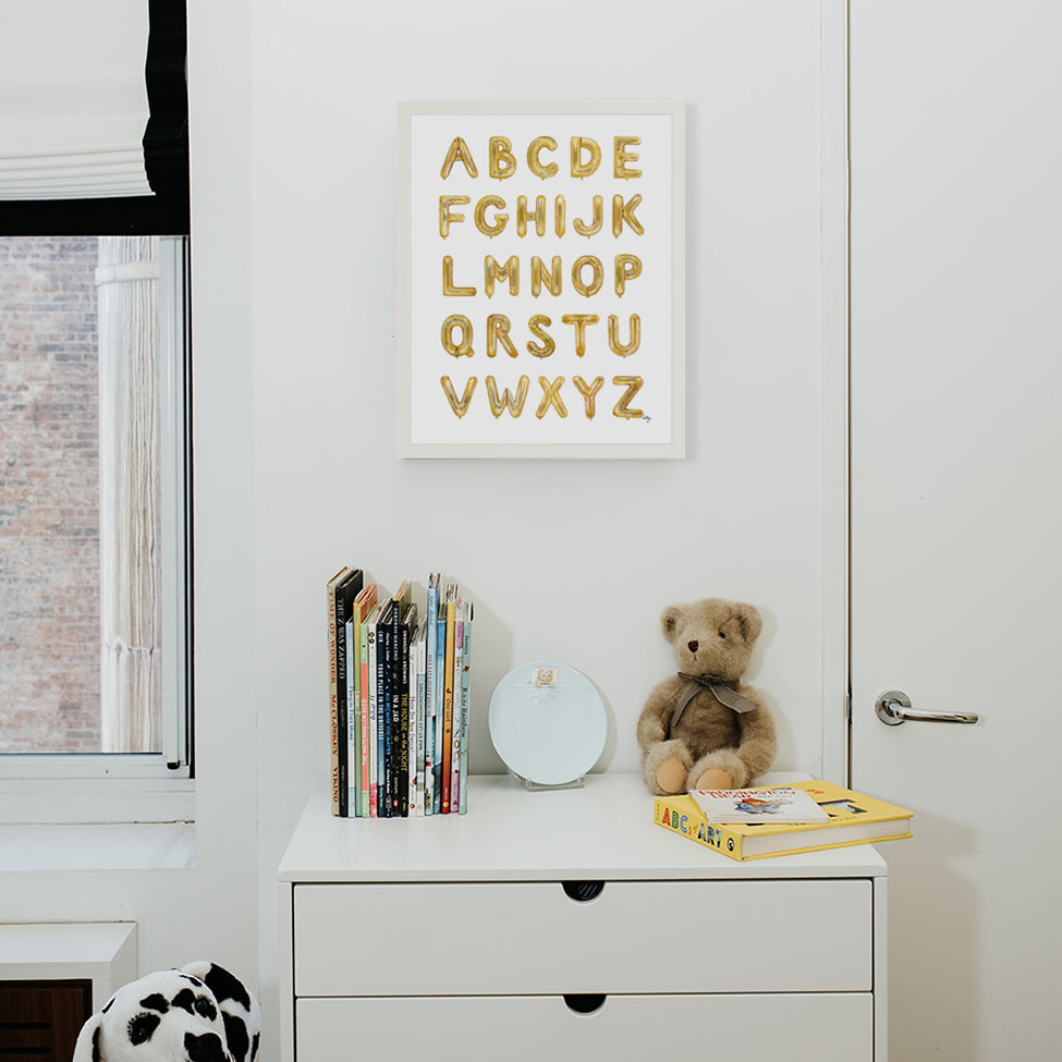 Gold Balloon Alphabet from The Letter Nest, White Frame installed in nursery