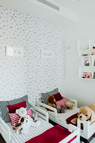 Shared kids' room with two toddler beds and custom name prints for Max and Alex by The Letter Nest