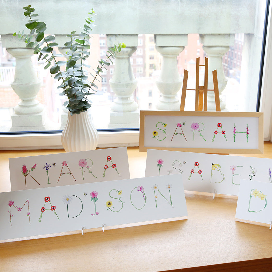 Flower Custom Name Prints styled in windowsill with framed and unframed examples