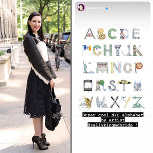 Jill Kargman poses next to her Instagram caption: "Super cool NYC alphabet by artist @sallykingmcbride!" 
