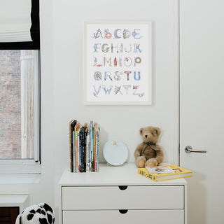 Nautical Alphabet in a White Frame from The Letter Nest, shown in a children's nursery