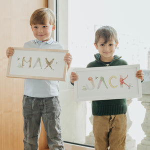 Max and Jack hold their custom Animal Name Prints